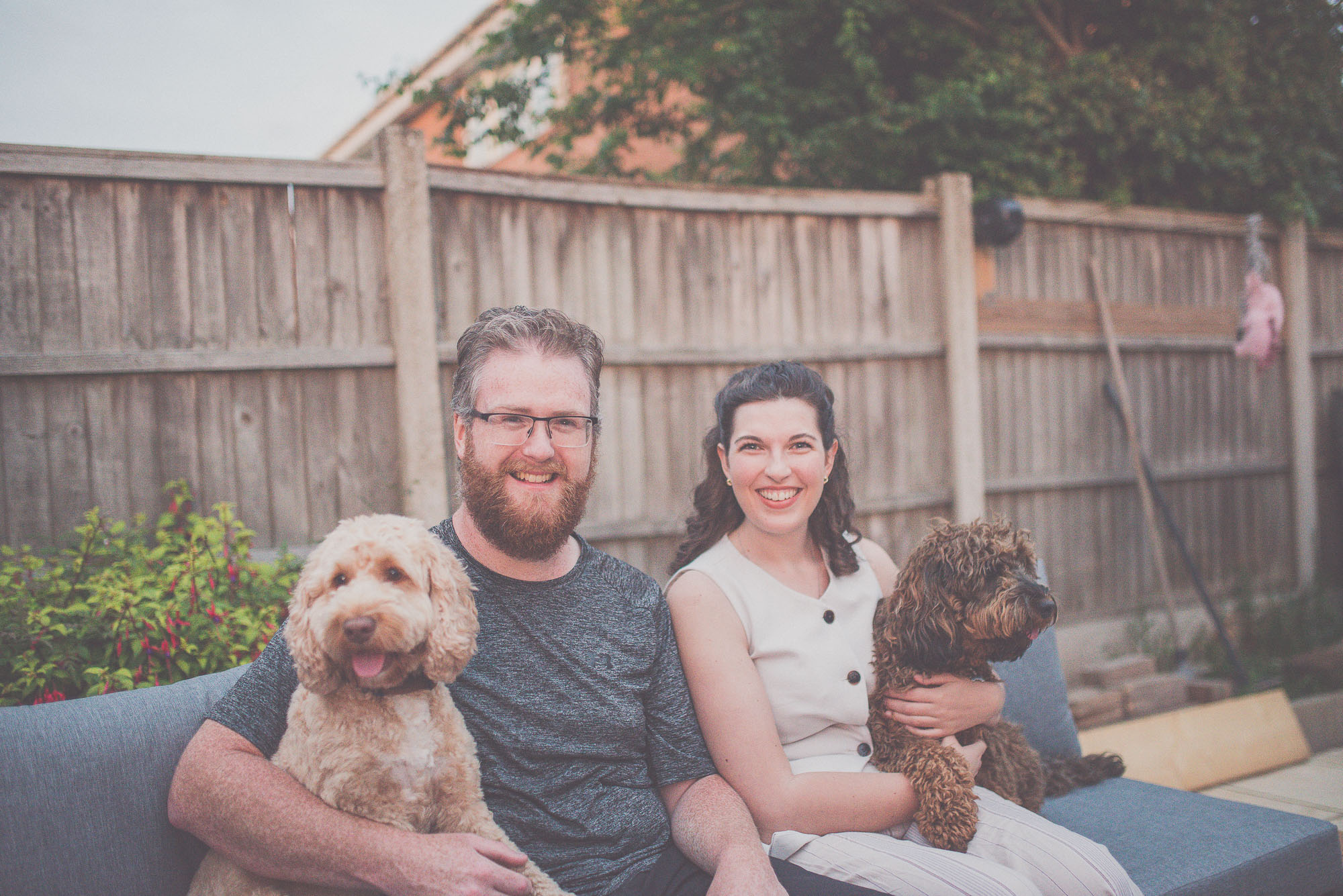 Personalised Veterinary Care for Pets and Their Families | Mainliacht Surgical Pet owners sitting with their dogs representing compassionate veterinary surgical care provided by Mainliacht Surgical.